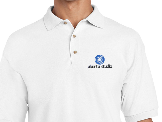 A close-up of a person wearing a white polo shirt featuring the 'Ubuntu Studio' logo on the left chest area.